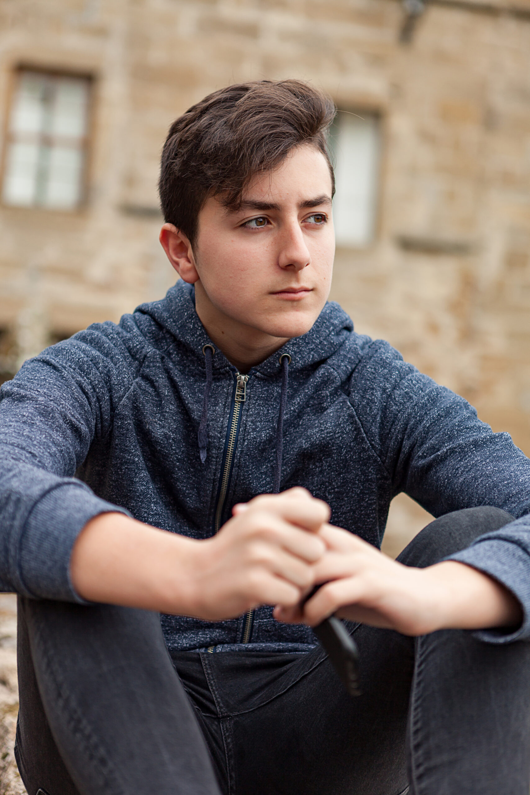 boy in hoodie looking to the side of the camera
